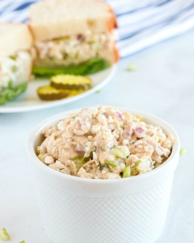 Cottage Cheese Tuna Salad in a small white bowl, with a sandwich in the background