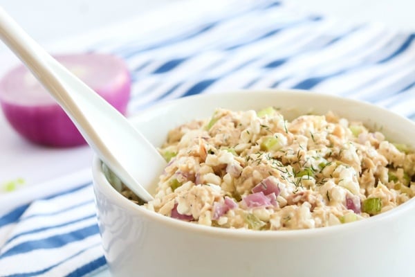 Cottage cheese tuna salad in a white bowl with a mixing spoon