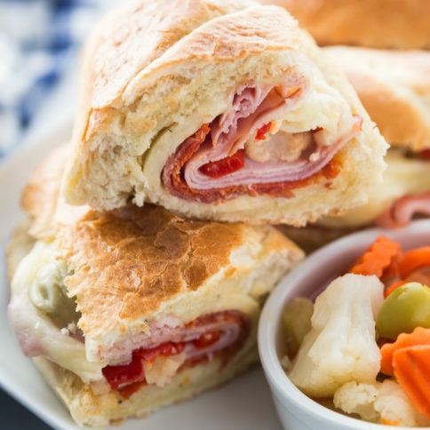 Hot Italian Sandwiches served on a white plate with a side of Giardiniera Mix