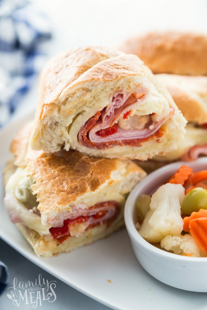 Hot Italian Sandwiches served on a white plate with a side of Giardiniera Mix