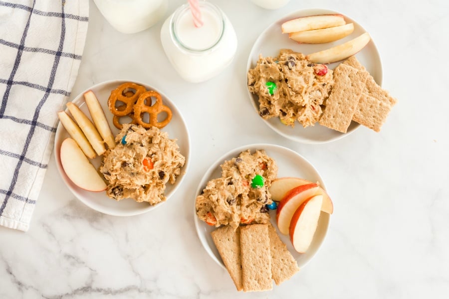 3 small white plates with dip, apples and graham crackers