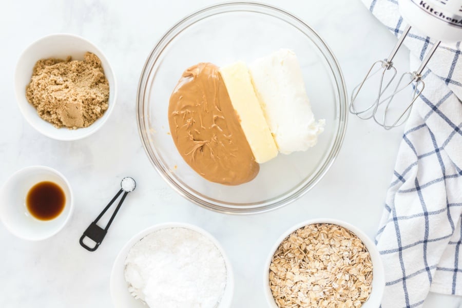 vanilla, sugars and oats in small white bowls. Butter cream cheese and peanut butter in later mixing bowl