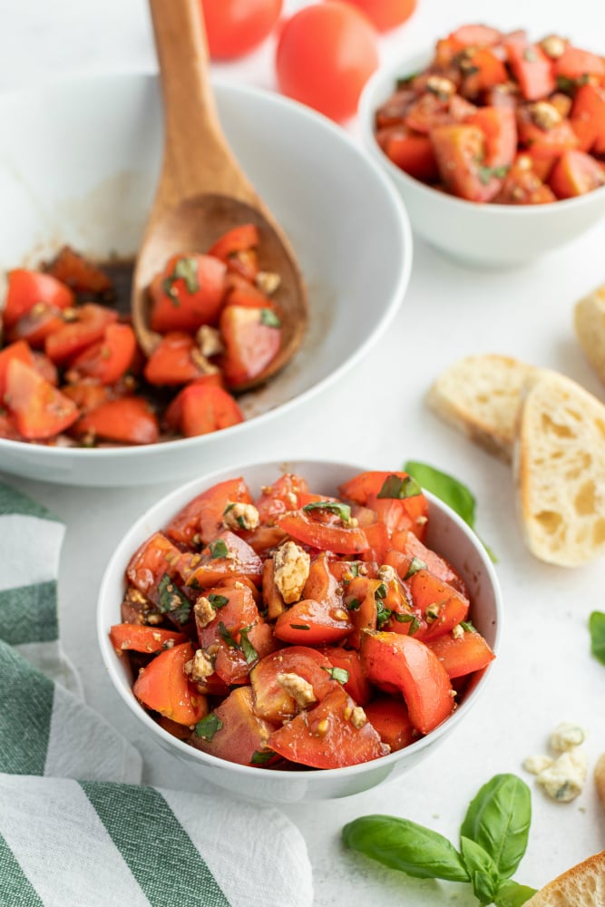  Balsamic Tomato Salad recipe served in a two small white bowl with a side of french bread