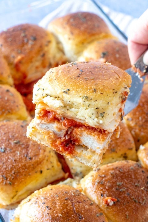 Serving a chicken parmesan slider with a serving spatula