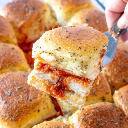 Serving a chicken parmesan slider with a serving spatula