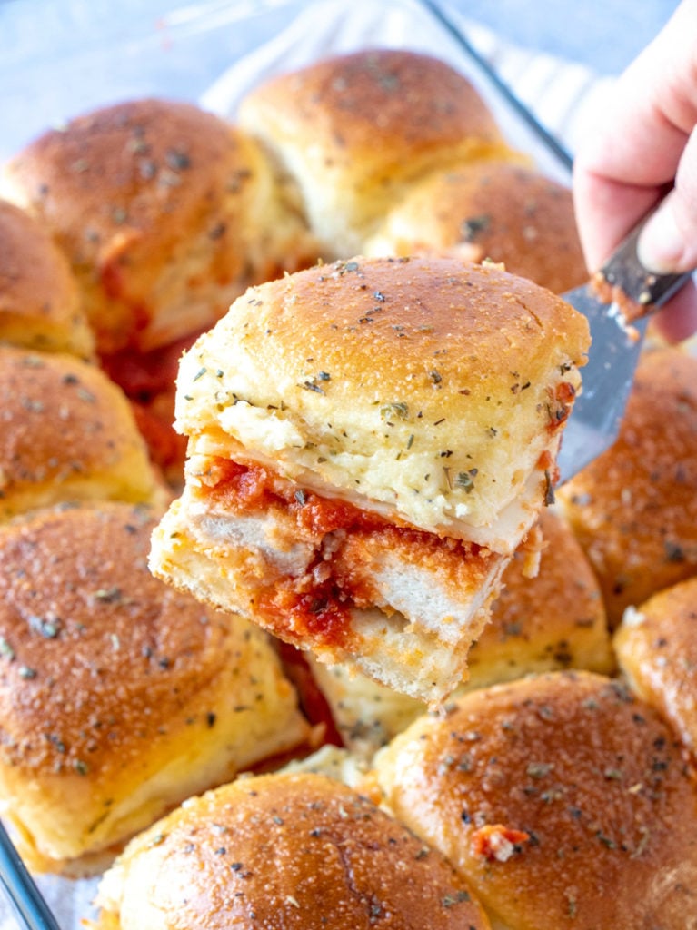 Serving a chicken parmesan slider with a serving spatula