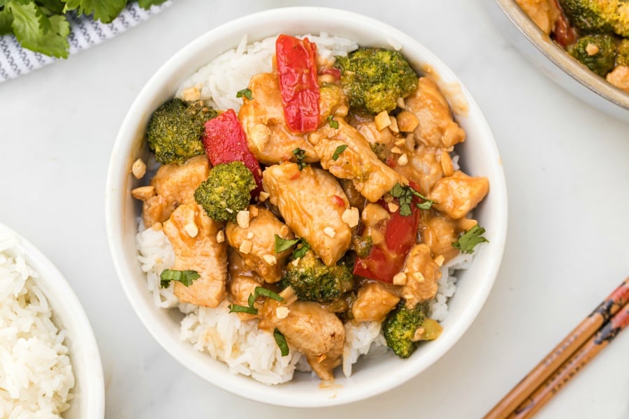 Easy Thai Peanut Chicken served over rice in a white bowl