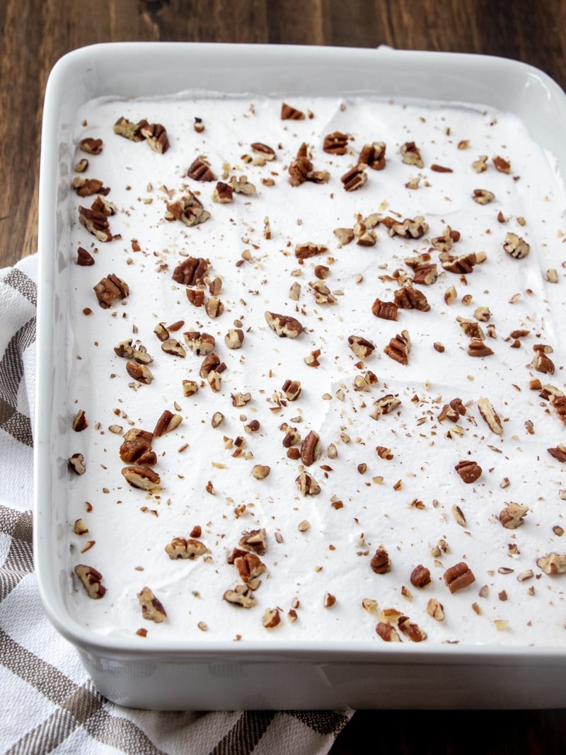 finished butterscotch lush cake, topped with chipped pecans