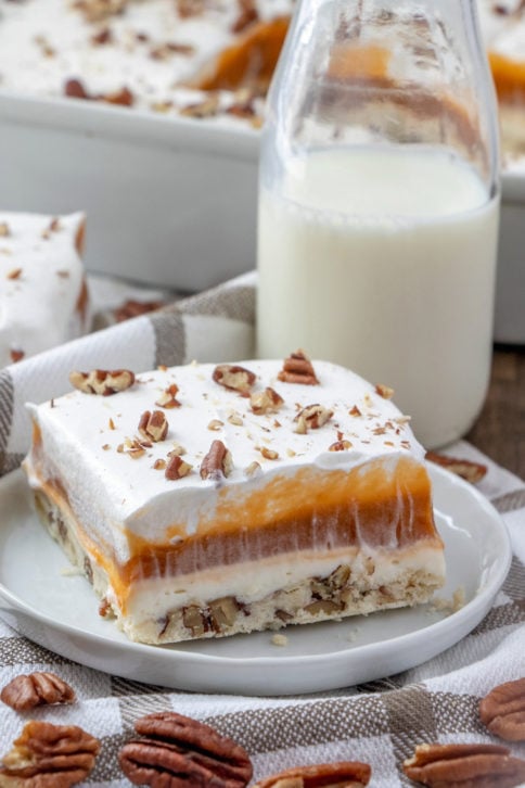 slice of butterscotch lush cake on a white plate