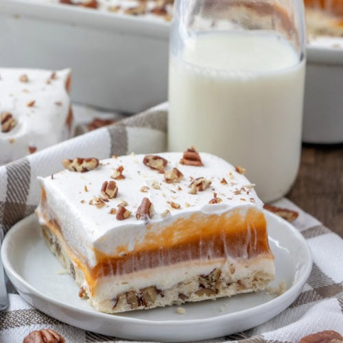 slice of butterscotch lush cake on a white plate