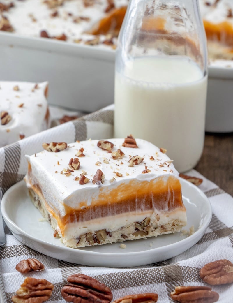 slice of butterscotch lush cake on a white plate