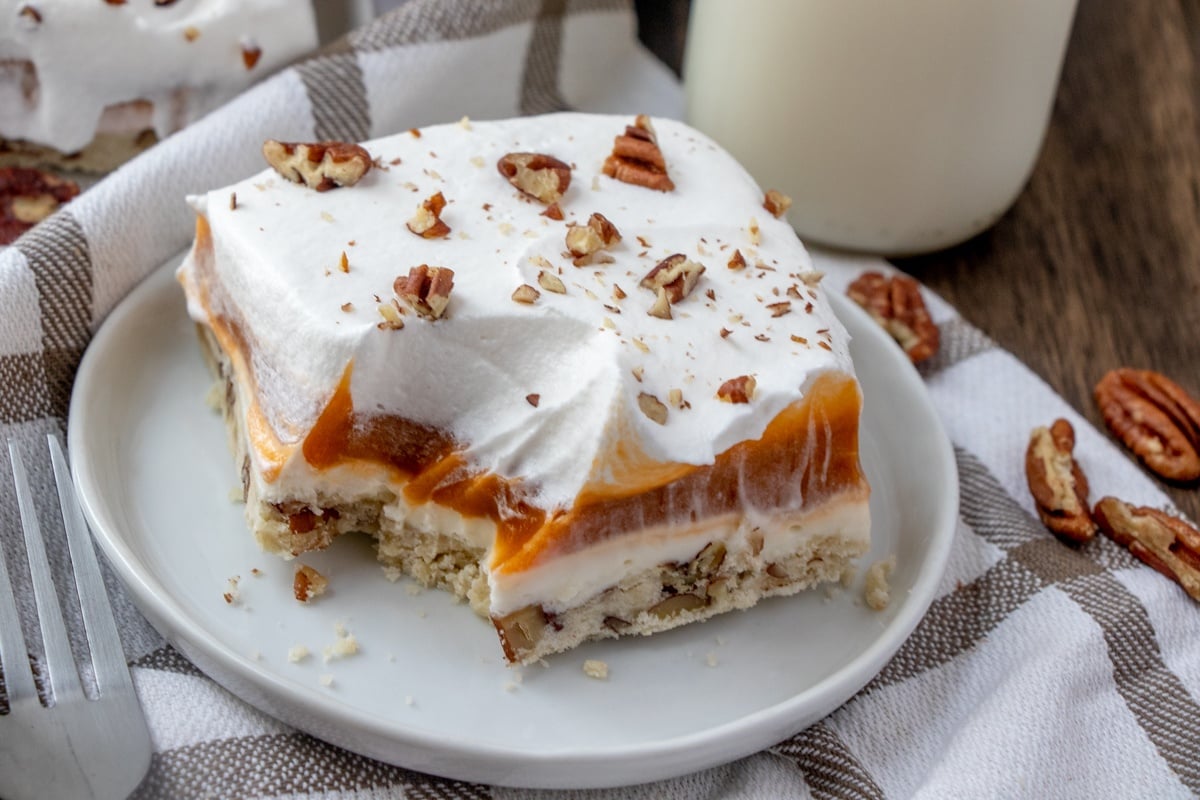 slice of butterscotch lush cake on a white plate