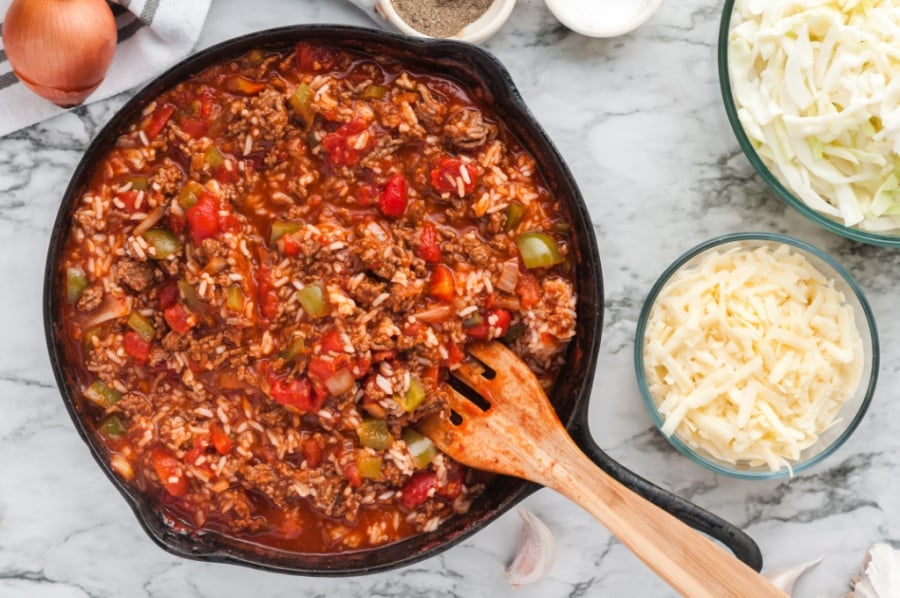 Cooked rice being added to beef mixture