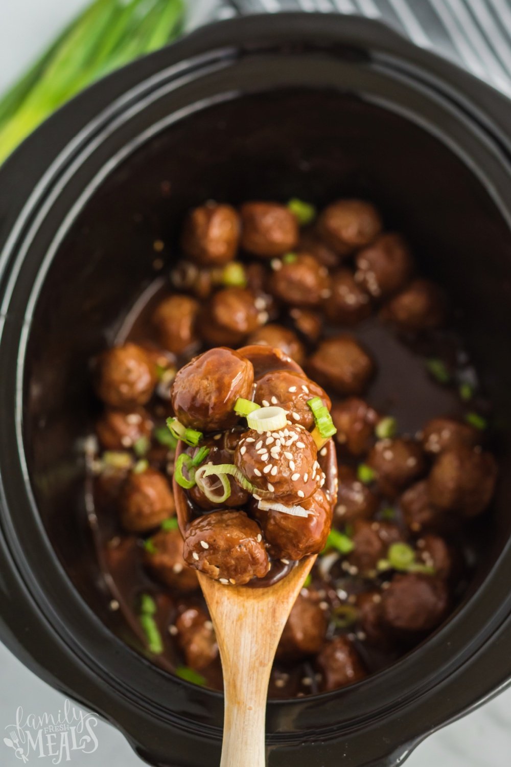 Crockpot Teriyaki Meatballs being lifted scooped up with a spoon