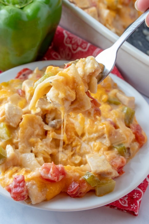 King Ranch Chicken Casserole served on a white plate with a fork scooping up a bite