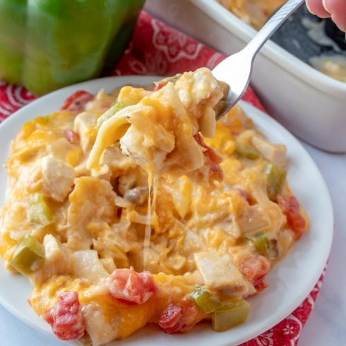 King Ranch Chicken Casserole served on a white plate with a fork scooping up a bite