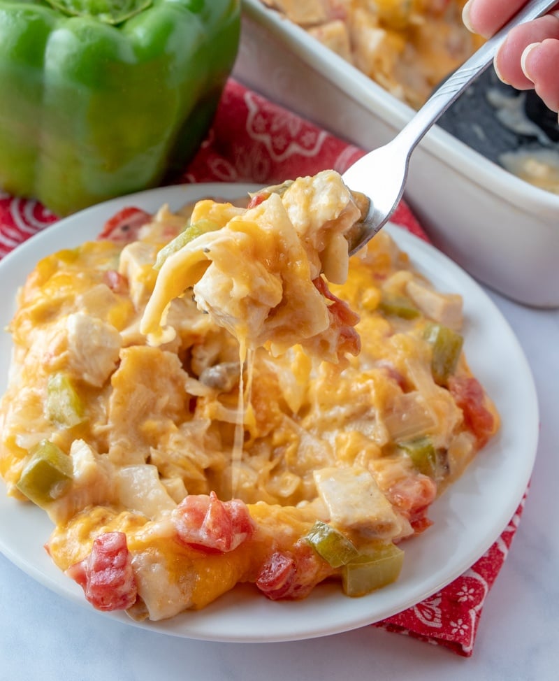 King Ranch Chicken Casserole served on a white plate with a fork scooping up a bite