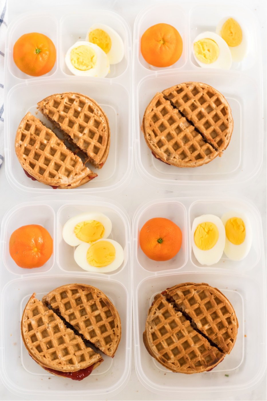 Top down image of 4 PBJ Waffle Sandwich Lunchboxes via @familyfresh