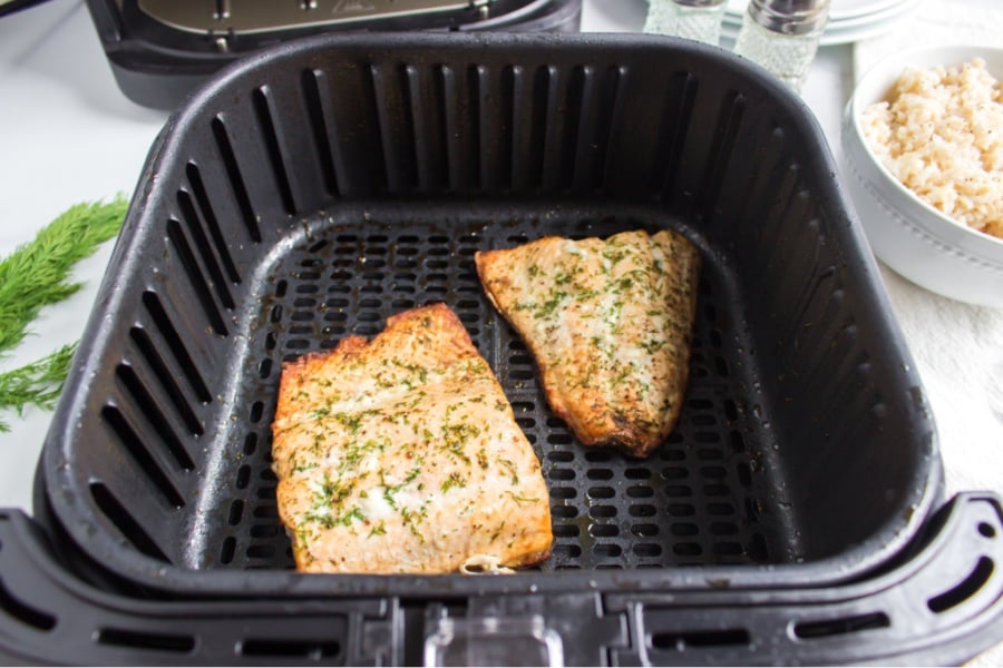 cooked air fryer salmon in air fryer basket