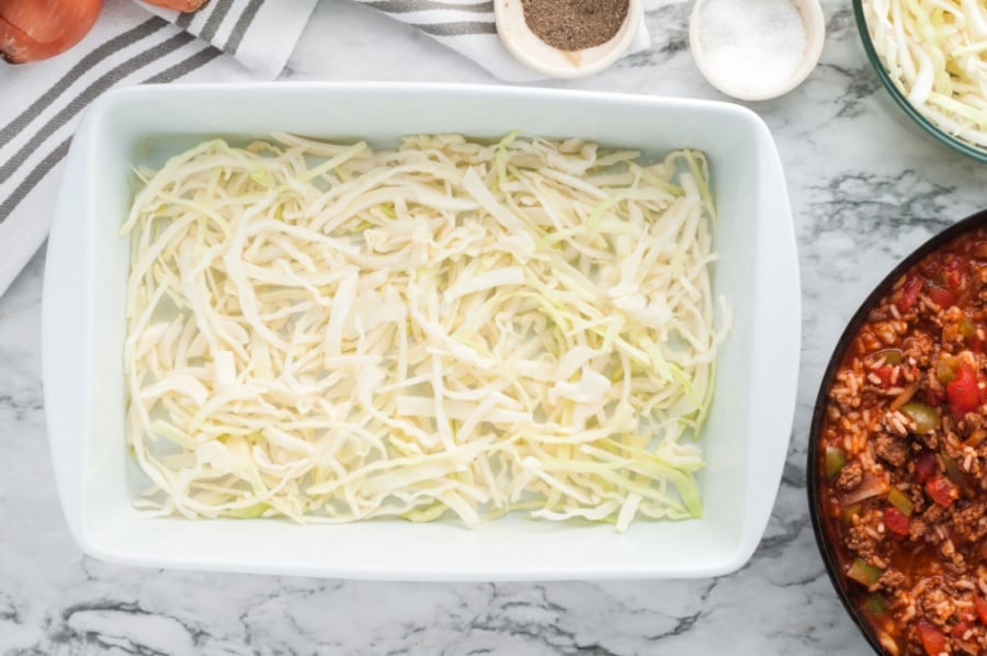 shredded cabbage placed in the bottom of a baking pan
