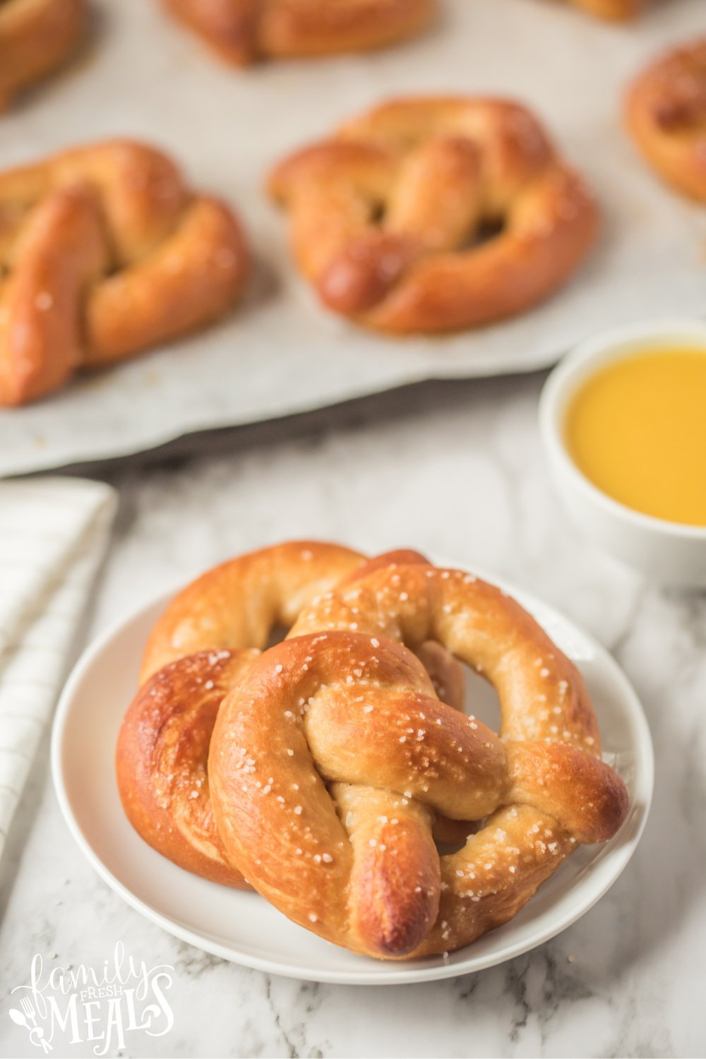two soft pretzels on a white plate