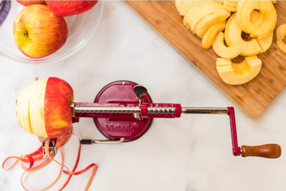 apple being peeled on an apple peeler