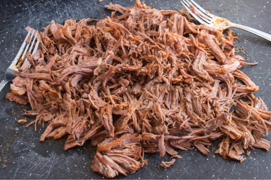 Shredded beef on a cutting board