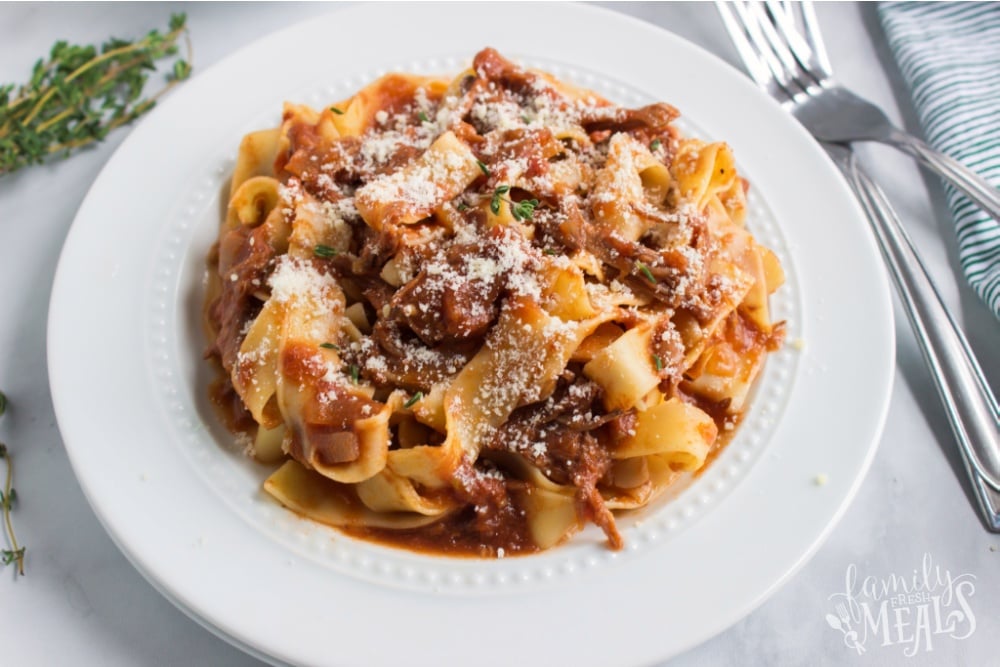 ragu served with noodles on a white plate