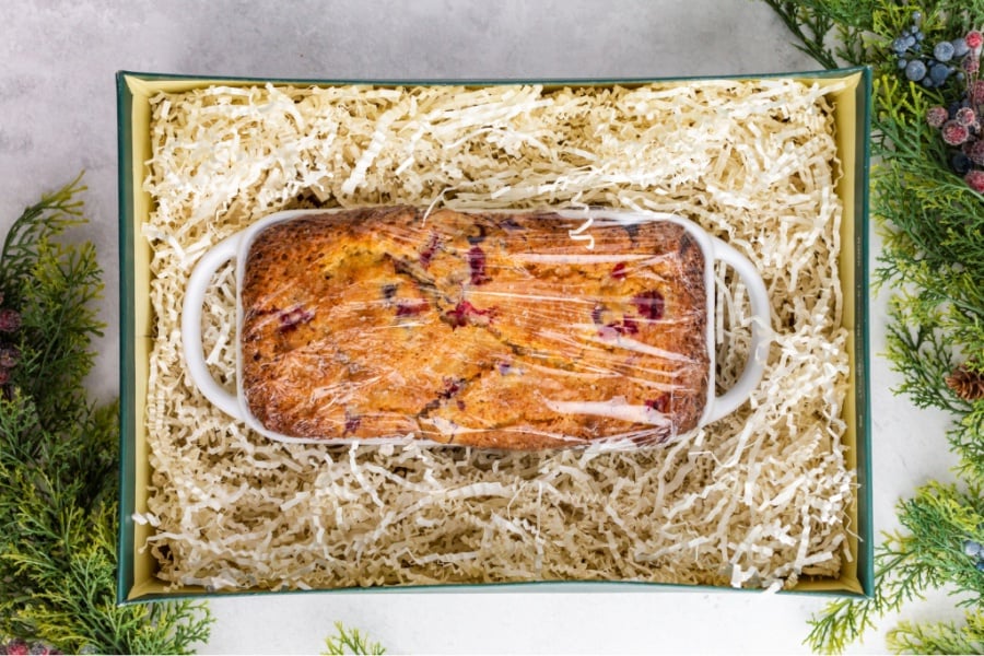 loaf of bread wrapped with plastic wrap, in a gift box