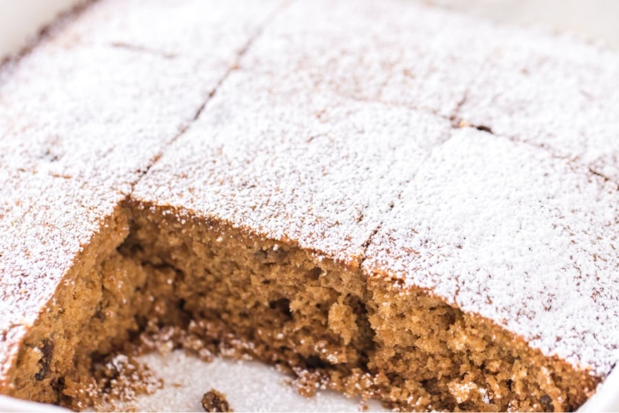 applesauce cake in baking dish with a couple pieces removed