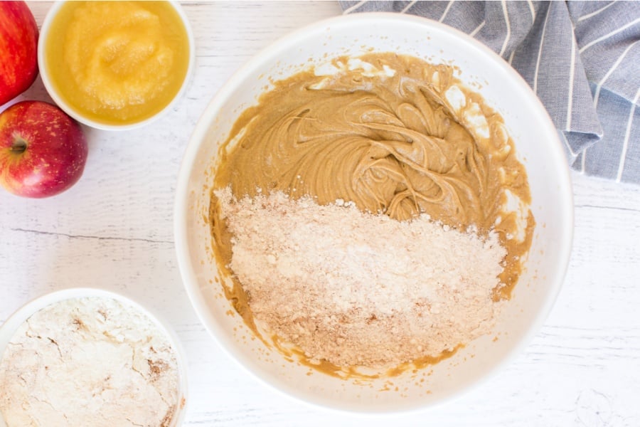 adding dry ingredients to mixing bowl