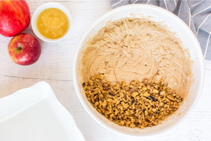 adding walnuts to mixing bowl