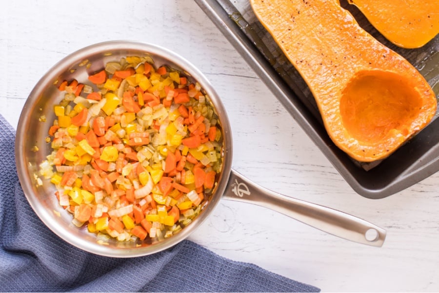 chopped veggies in a sauce pan with cooked squash in a pan