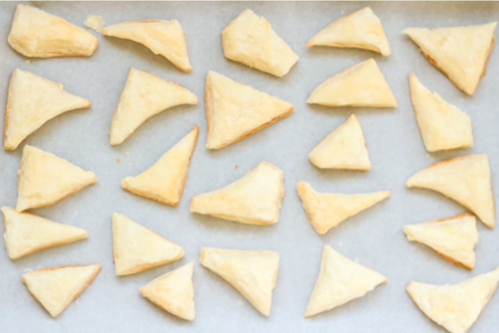 puff pastry triangles on a baking sheet