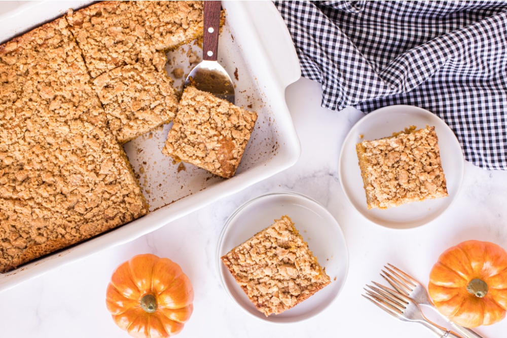 pan of pumpkin coffee cake, with some pieces removed and on plates