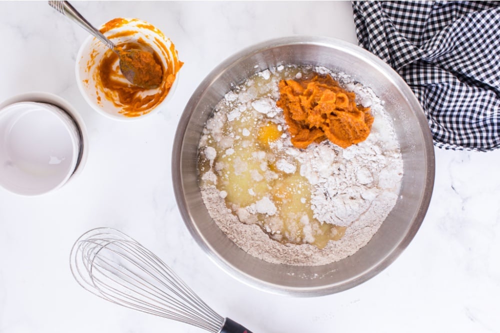 milk, pumpkin puree, vegetable oil, and eggs added to the mixing bowl