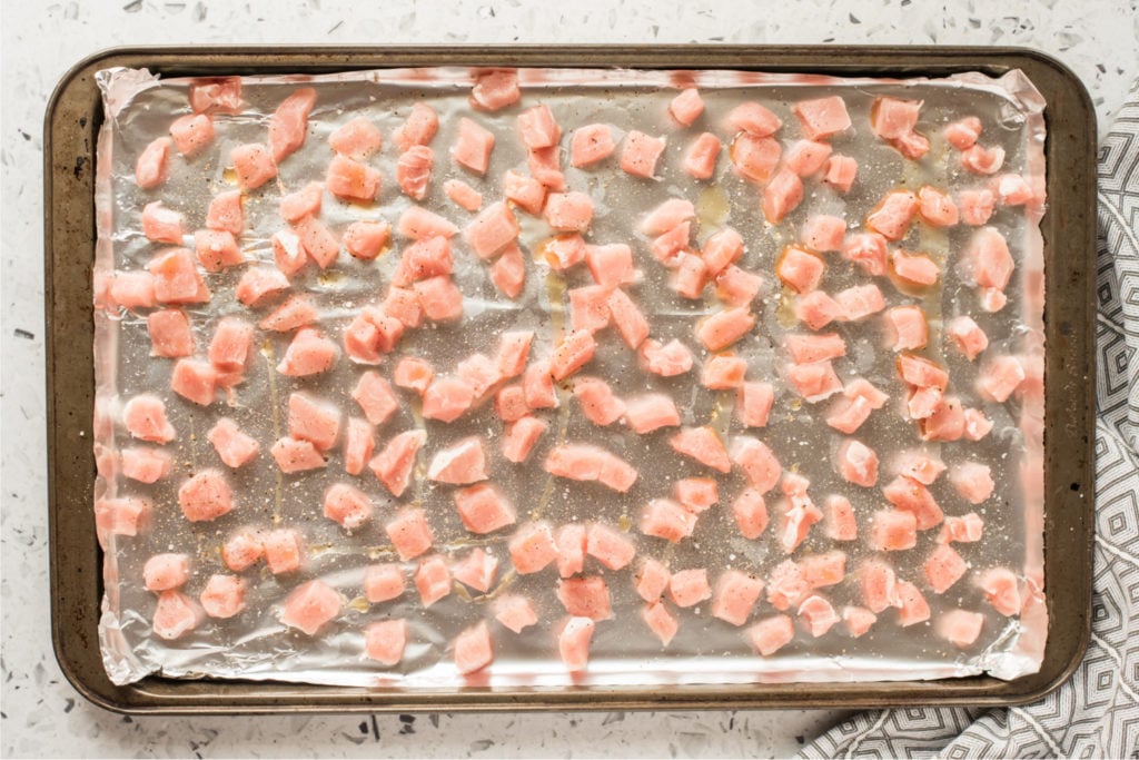 raw pork pieced on a baking sheet