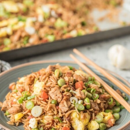 pork fried rice served on a plate with chopsticks