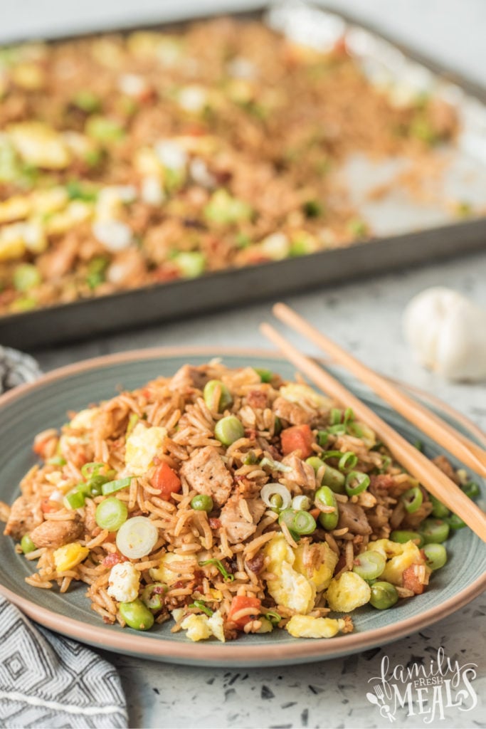 pork fried rice served on a plate with chopsticks