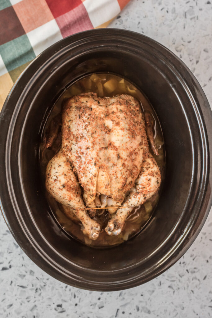 whole cooked chicken in a crockpot