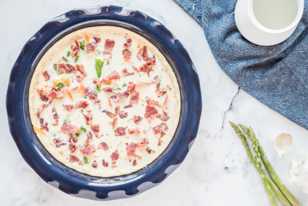 egg mixture and bacon added to pie pan