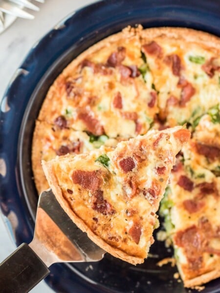 Asparagus Bacon Quiche with a piece being taken from pan