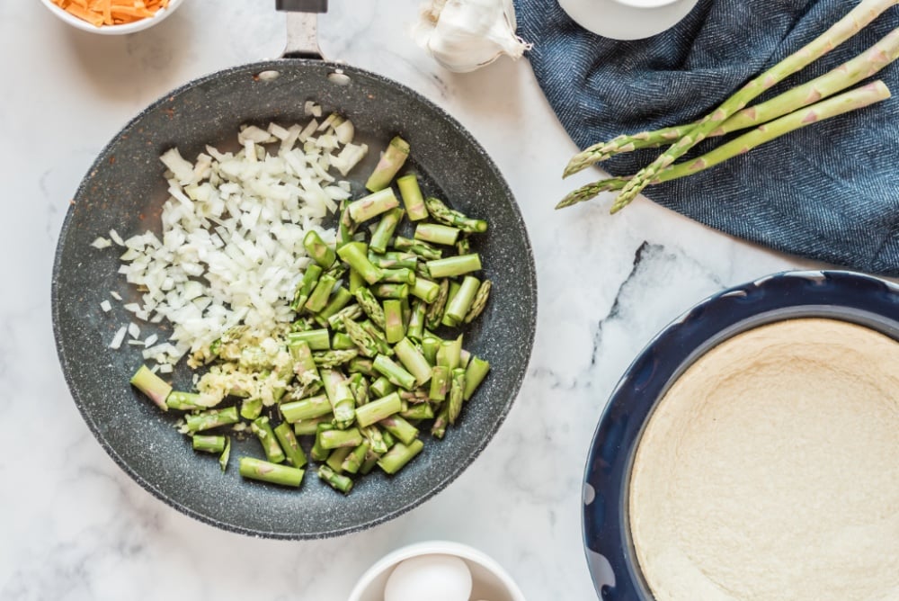 onion, asparagus, and garlic added to pan