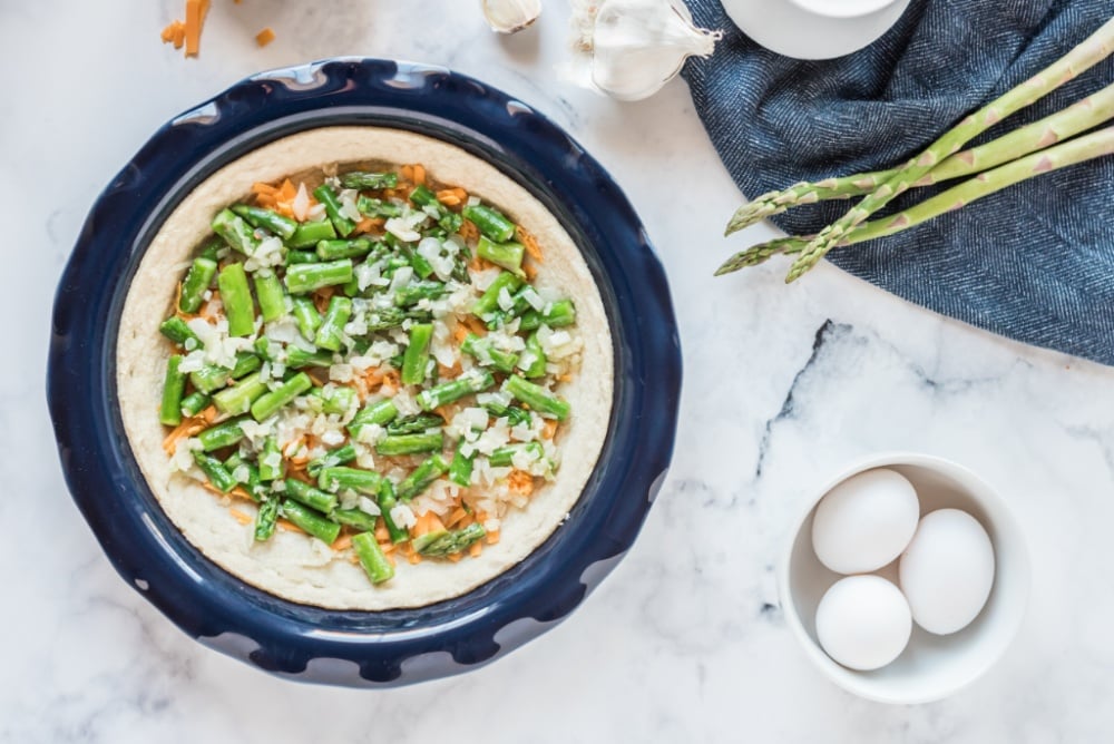 shredded cheese, onion, asparagus, and garlic added to pie crust