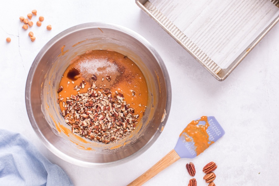 cinnamon, vanilla, and chopped pecans being added to butterscotch mixture