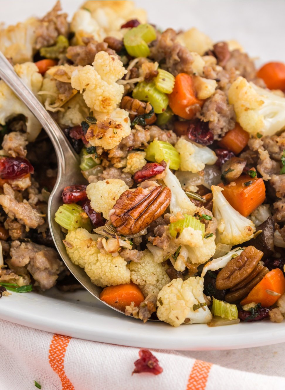 This Savory Cauliflower Stuffing tastes exactly like stuffing. It’s loaded with all the traditional flavors of onion, herbs, sausage, veggies, cranberries and nuts. via @familyfresh
