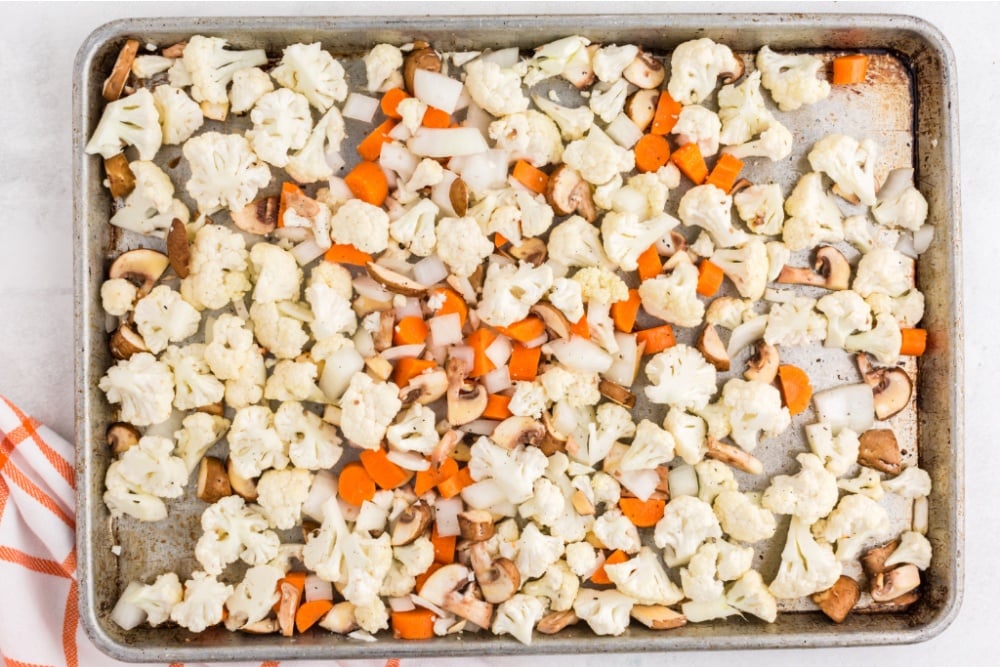 cauliflower, mushroom and carrots on a baking sheet