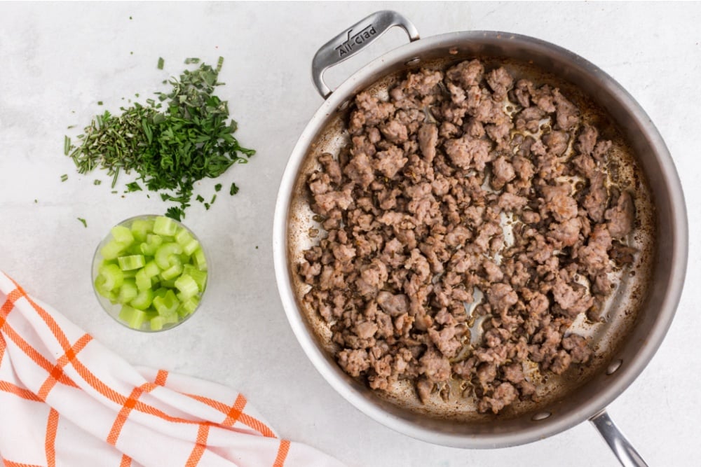 sausage being browned in a cooking pan