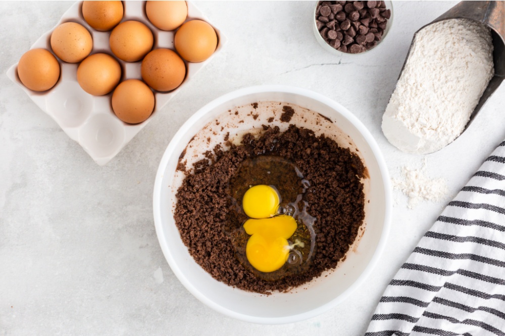 eggs being added to mixing bowl