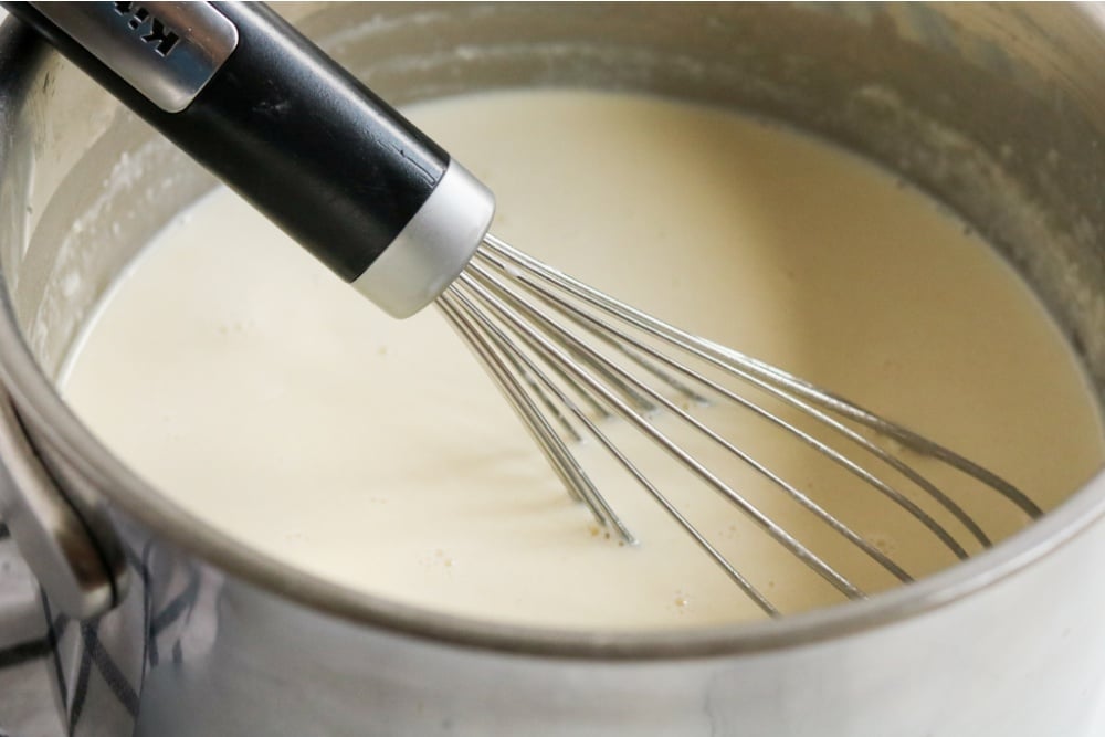 whisking together butter, milk, and flour